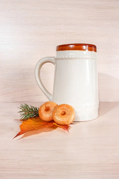 Ceramic beer mug,pine branches and mushrooms on a light background — Stock Photo, Image