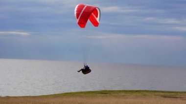 Paraglider flying over Hammars Backar, Sweden