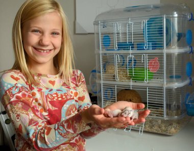 Girl with newborn hamsters clipart