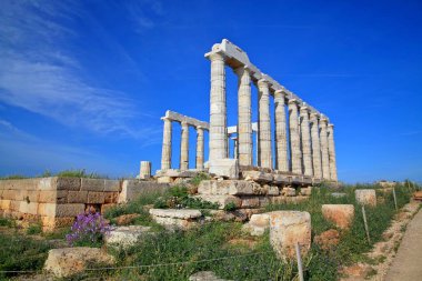 The ruins of the Temple of Poseidon at the legendary Cape Sounion in Greece. Among some historians, it is believed that the Temple of Poseidon was built by the inhabitants of the mysterious Atlantis, and not by the Greeks, back in 440 BC. clipart