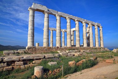 The ruins of the Temple of Poseidon at the legendary Cape Sounion in Greece. Among some historians, it is believed that the Temple of Poseidon was built by the inhabitants of the mysterious Atlantis, and not by the Greeks, back in 440 BC. clipart