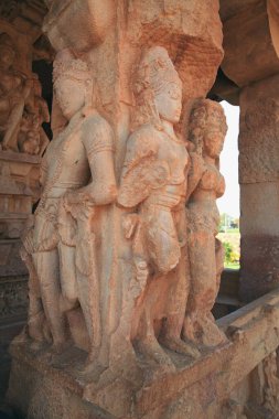 The interior of Hindu temples - sculptural images of the Gods, heroes of the ancient Indian epic, sculptural reliefs, carved ornaments, murals on mythological themes, flagpole columns. Durga Temple and others, Aikhole, Karnataka, India clipart