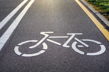 Bisiklet lane işareti ve güneş ışınları ile Bisiklet yol yüzeyinde görüntüsünü
