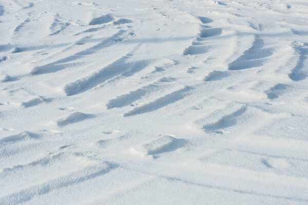 Curvy car tracks in the snow background