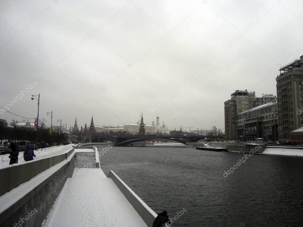 Bridge over the Moskva river. View of the Moscow Kremlin on a cloudy wet winter day..