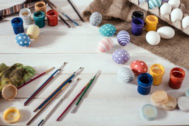 Paskalya için hazırlık. Renkli el yapımı Paskalya yumurtaları boya, fırça üzerinde beyaz ahşap arka plan donatmak