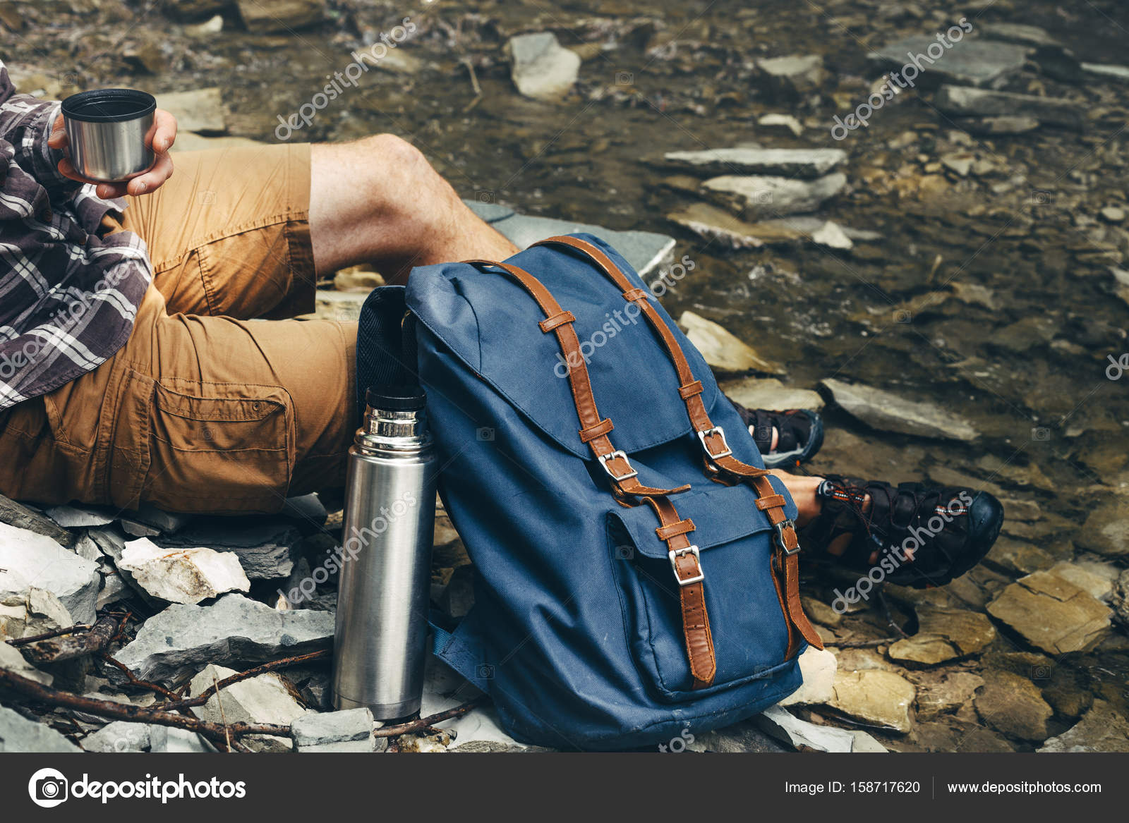 Unrecognizable hiker man drink tea or coffee from thermos Hiking