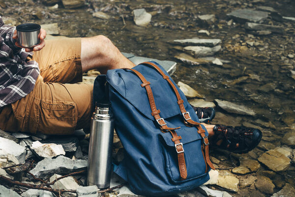 Unrecognizable hiker man drink tea or coffee from thermos Hiking Resting Concept