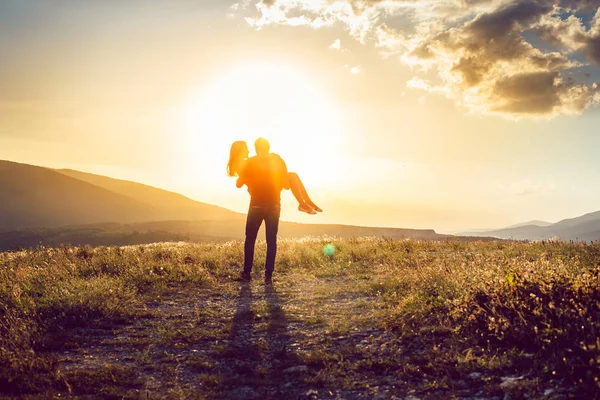 Genç kız güzel günbatımı zemin üzerine ellerinde adam