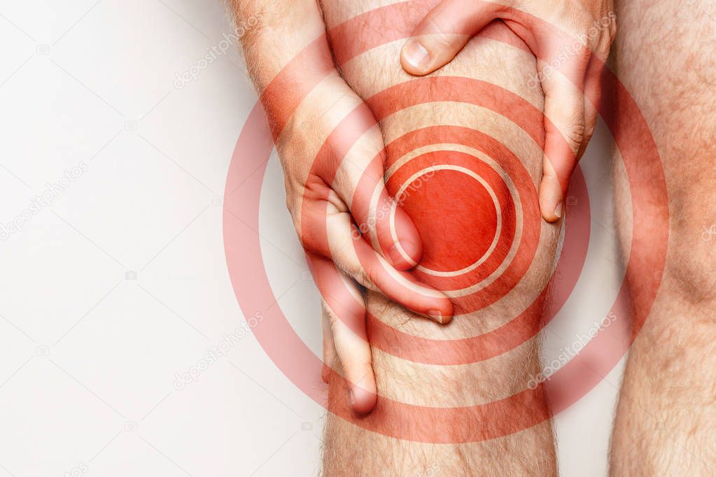 Acute pain in a knee joint, close-up. Color image, isolated on a white background. Pain area of red color
