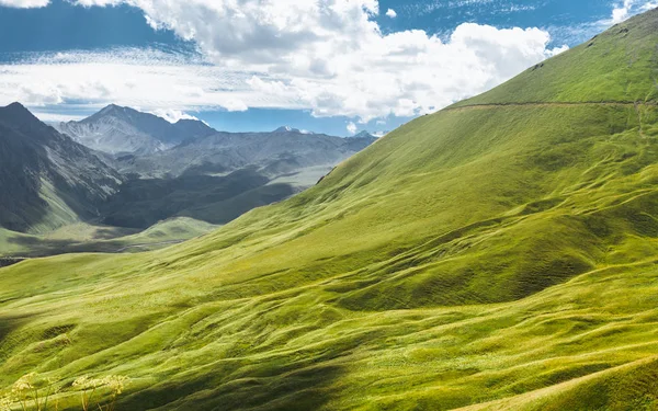 Picturesque Mountain Landscape. Green Hill And Mountain Range On A Sunny Summer Day. Elbrus Region, North Caucasus, Russia — Stock Photo, Image