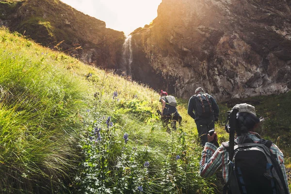 Group Of Tourists Walking Uphill To Waterfall. Travel Adventure Outdoor Concept — Stock Photo, Image