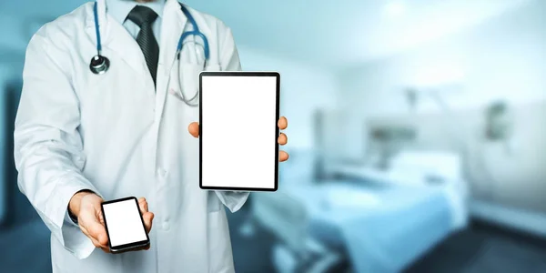 Doctor Holds Smartphone And Digital Tablet With Copy Space And Clipping Path For Screen In Hospital