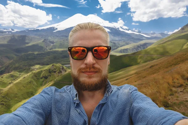 El joven viajero se hace selfie en el fondo del monte Elbrus. Aventura Destino Viaje Concepto — Foto de Stock