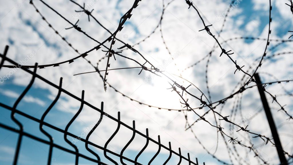 Barbed Wire Fence Against Blue Sky. Freedom Jail Independence Silence Loneliness Concept