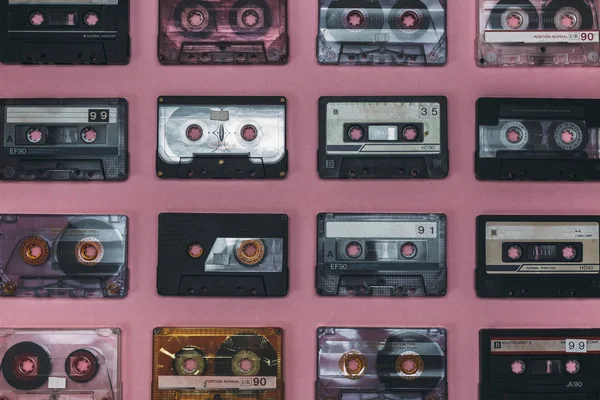 Collection Of Retro Audio Tapes On Lilac Background, Top View. Retro Technology Music Concept