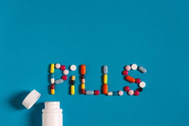 Word hapları renkli hapları ve tabletler üzerinde mavi bir arka plan ile. Yaratıcılık tıp kavramı