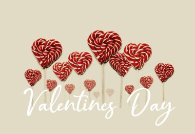 Heart Shaped Lollipops In Row On Yellow Background with Text. Global Concept And Symbol Of Love. Love and Holiday Greeting Card Backgroun