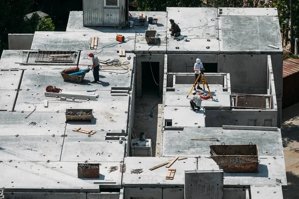 Quatro Trabalhadores Piso Superior Edifício Estão Instalando Pisos Concreto Dia — Fotografia de Stock