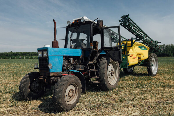 Big blue trabig blue tractor with big wheels in a field in summer at an agricultural exhibitionctor with big wheels in a field in summer
