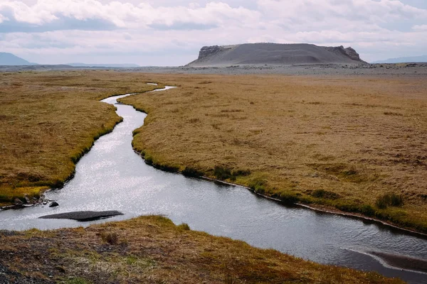 clean river and extinct volcano in iceland in summer on a sunny day