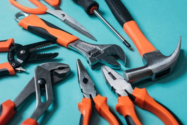 group bunch of tools with orange handles on a blue background