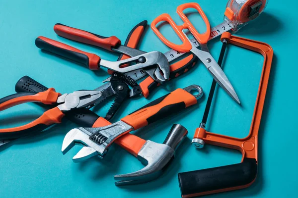 group bunch of tools with orange handles on a blue background