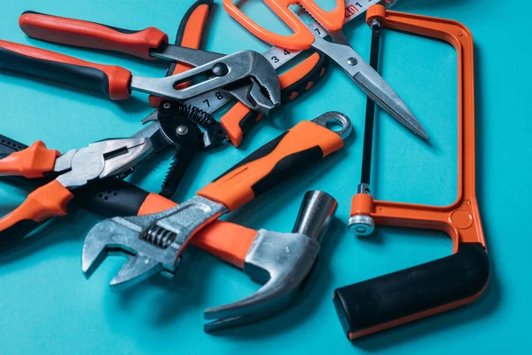 group bunch of tools with orange handles on a blue background