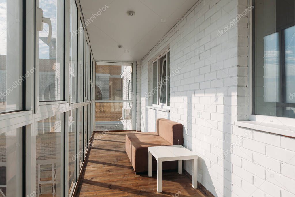 modern white loggia balcony in a residential building on the top floor on a sunny morning