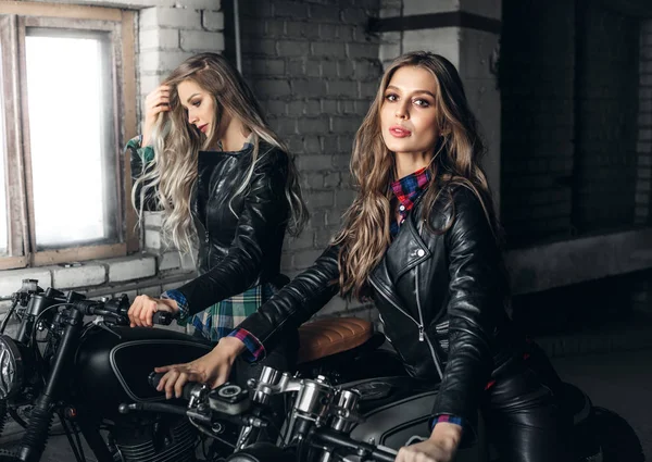 Bikers women in leather jackets with motorcycles