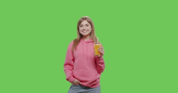 Jovem mulher bonita bebe suco de laranja — Vídeo de Stock