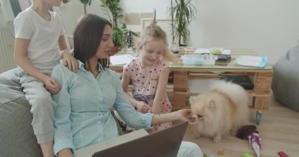 Šťastná maminka a roztomilé děti pomocí notebooku doma — Stock video