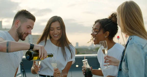 Giovane aprendo bottiglia di champagne — Foto Stock