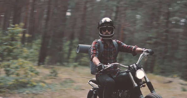 Young rider driving motorcycle on forest road — Stock Photo, Image