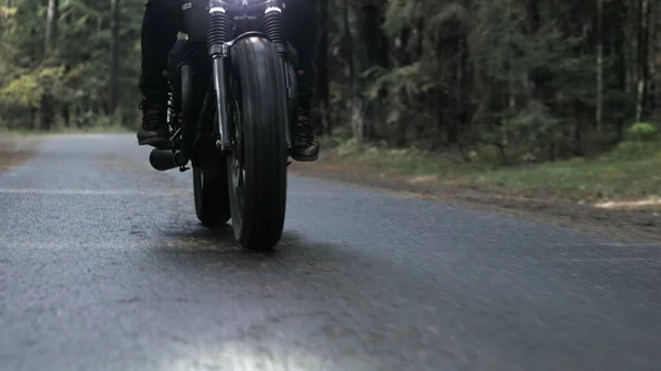 Guy rijden motorfiets op bosweg — Stockfoto