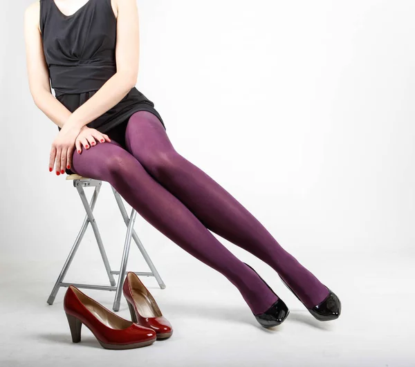 Woman\'s Legs Wearing Pantyhose and High Heels