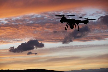 Yenilik kavramı. Günbatımı üzerinde uçan uçak silueti. Ağır dron fotoğraf çekme Kaldır