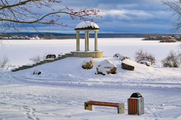 Zimowy krajobraz pierwszy śnieg na nabrzeżu stawu miejskiego o zachodzie słońca. Pierwszy śnieg w parku. — Zdjęcie stockowe