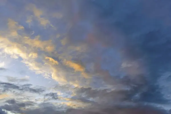 Ο ουρανός στο ηλιοβασίλεμα. Πυκνό σύννεφα φωτίζονται από τις ακτίνες του ήλιου που δύει. — Φωτογραφία Αρχείου