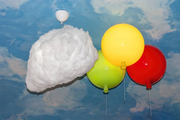 Fragment of a ceiling stylized as a vault of heaven with lamps in the form of clouds and balloons. — Stock Photo, Image