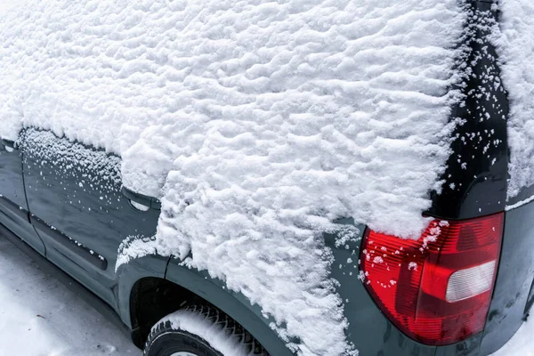 A car covered with a thick layer of snow closeup.