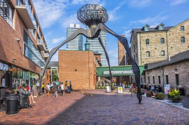 TORONTO, CANADA - AUGUST 24, 2017: Distillery District (former Gooderham &Worts Distillery) - historic and entertainment precinct. It contains numerous cafes, restaurants, shops and industrial parts. clipart