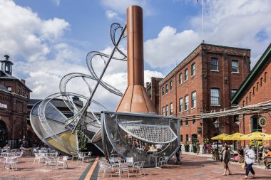TORONTO, CANADA - AUGUST 24, 2017: Distillery District (former Gooderham &Worts Distillery) - historic and entertainment precinct. It contains numerous cafes, restaurants, shops and industrial parts. clipart