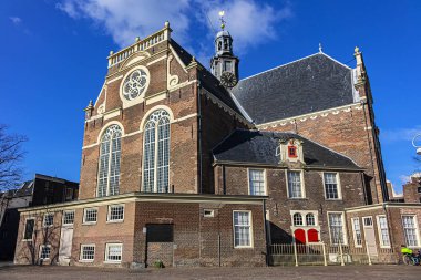 View of Northern church (Noorderkerk) - XVII century Protestant church in Amsterdam. Noorderkerk is located along Prinsengracht canal, on the Noordermarkt square. Amsterdam, Netherlands.