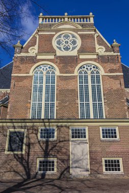 View of Northern church (Noorderkerk) - XVII century Protestant church in Amsterdam. Noorderkerk is located along Prinsengracht canal, on the Noordermarkt square. Amsterdam, Netherlands.