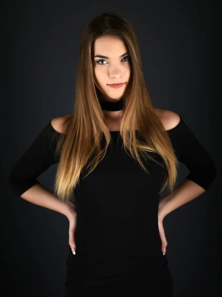 Beautiful sexy white woman in black dress posing at studio — Stock Photo, Image