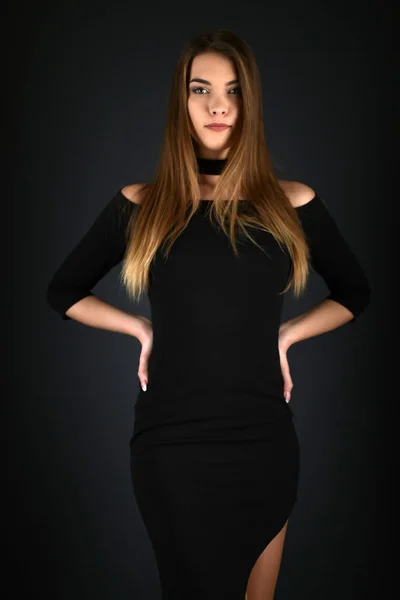 Beautiful sexy white woman in black dress posing at studio — Stock Photo, Image