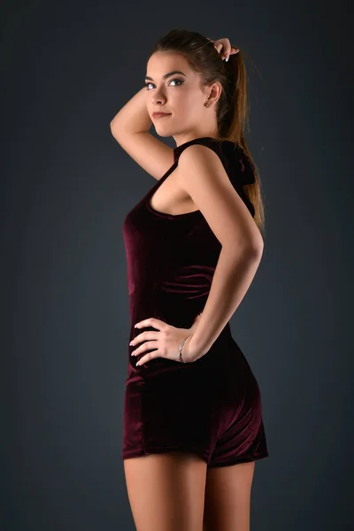 Beautiful sexy white woman in black dress posing at studio — Stock Photo, Image