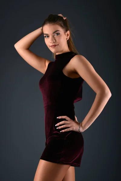 Beautiful sexy white woman in black dress posing at studio — Stock Photo, Image