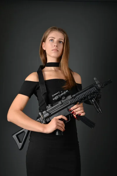 Beautiful woman with gun — Stockfoto